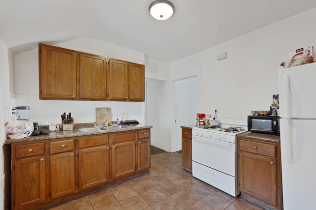 1917 Emerson St, Evanston, IL 60201 - kitchen featuring white appliances, a sink, backsplash, brown cabinetry, and light tile patterned floors