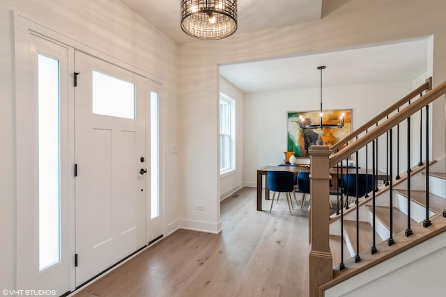 6030 Fairview Ave, Downers Grove, IL 60516 - entryway featuring a chandelier, light wood-type flooring, and stairs