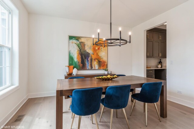 6030 Fairview Ave, Downers Grove, IL 60516 - dining space featuring light wood-type flooring and a chandelier