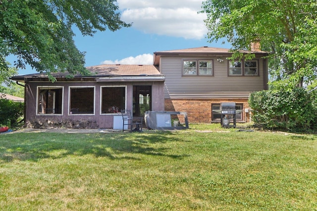 71 Ruggles Ct, Orland Park, IL 60467 - rear view of property featuring a chimney, a yard, and brick siding