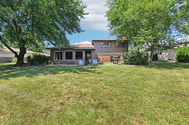 71 Ruggles Ct, Orland Park, IL 60467 - rear view of house with a yard, a chimney, and brick siding