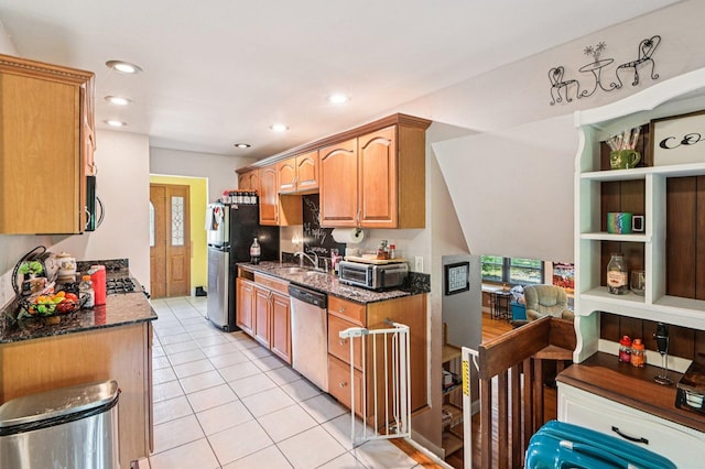 71 Ruggles Ct, Orland Park, IL 60467 - kitchen featuring appliances with stainless steel finishes, dark stone counters, light tile patterned floors, recessed lighting, and brown cabinets