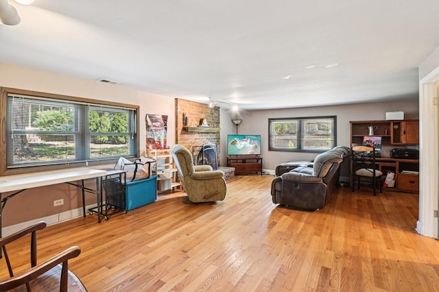 71 Ruggles Ct, Orland Park, IL 60467 - living room featuring light wood finished floors and a fireplace