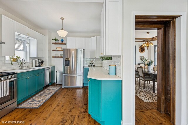 4058 N Kostner Ave, Chicago, IL 60641 - kitchen with appliances with stainless steel finishes, a sink, decorative backsplash, white cabinets, and light countertops