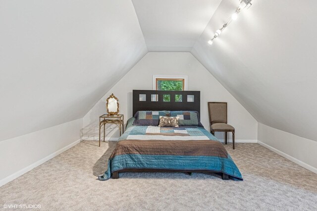 4058 N Kostner Ave, Chicago, IL 60641 - carpeted bedroom with lofted ceiling, baseboards, and rail lighting