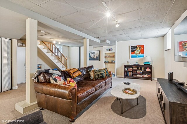 4058 N Kostner Ave, Chicago, IL 60641 - living room with light colored carpet, stairs, baseboards, track lighting, and a paneled ceiling