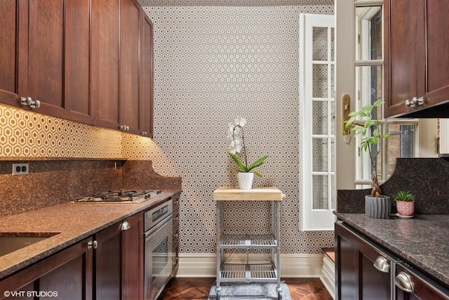 1350 N State Pkwy Unit Gs, Chicago, IL 60610 - kitchen featuring stainless steel appliances, decorative backsplash, and dark stone countertops