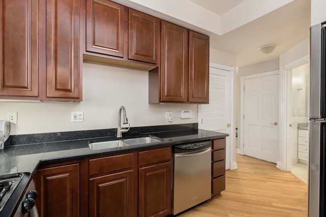 5331 S Harper Ave Unit 1, Chicago, IL 60615 - kitchen with stainless steel appliances, light wood-style floors, and dark stone counters