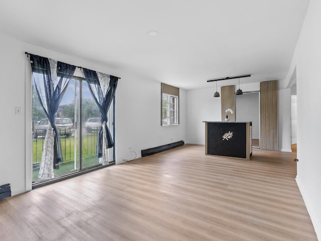 17963 Amherst Ct Unit 102, Country Club Hills, IL 60478 - unfurnished living room with light wood finished floors, a baseboard heating unit, and baseboards
