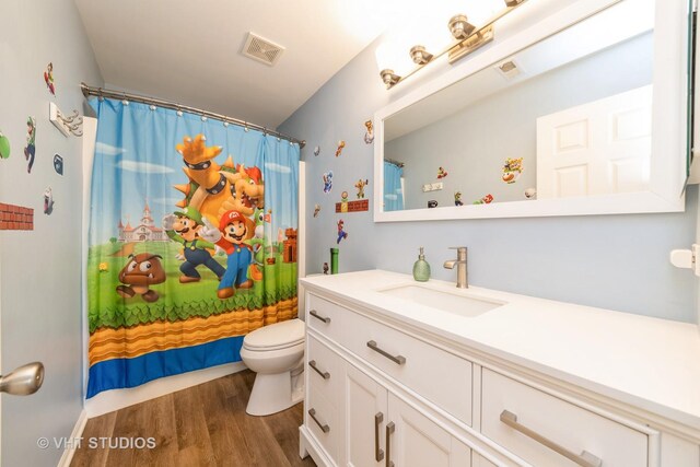 251 Boulder Ct, Gilberts, IL 60136 - full bathroom with vanity, wood finished floors, toilet, and curtained shower