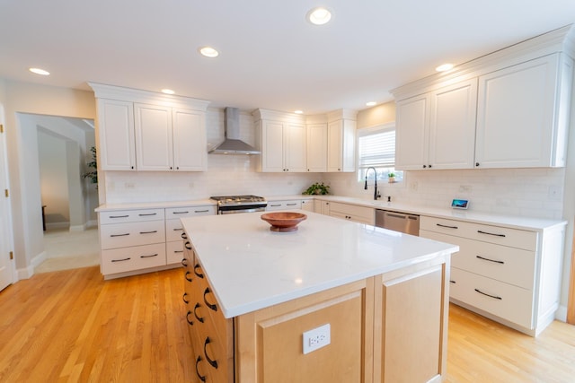 13119 Millbank Dr, Plainfield, IL 60585 - kitchen featuring wall chimney range hood, appliances with stainless steel finishes, light wood-type flooring, decorative backsplash, and recessed lighting