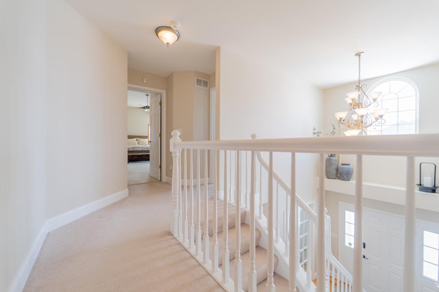 13119 Millbank Dr, Plainfield, IL 60585 - hallway with a chandelier, carpet flooring, an upstairs landing, and baseboards