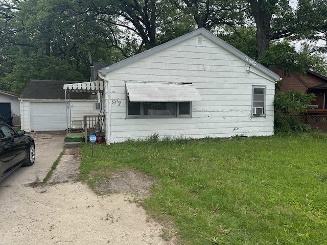 97 N Pearl St, Kankakee, IL 60901 - view of home's exterior featuring an outbuilding, driveway, a yard, and a detached garage