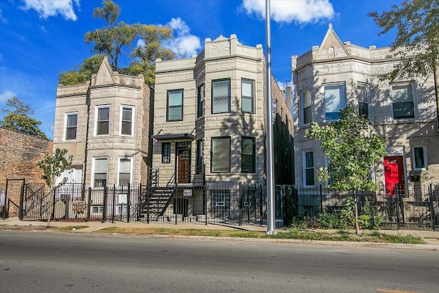 1829 S Kedzie Ave, Chicago, IL 60623 - townhome / multi-family property with a fenced front yard and stone siding