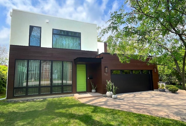 920 Appletree Ln, Deerfield, IL 60015 - contemporary house featuring concrete driveway, stucco siding, and a front lawn