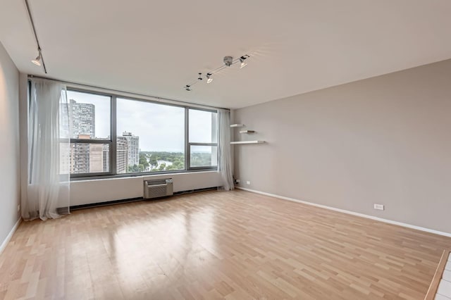 3600 N Lake Shore Dr Unit 1518, Chicago, IL 60613 - empty room with track lighting, light wood-style floors, and baseboards