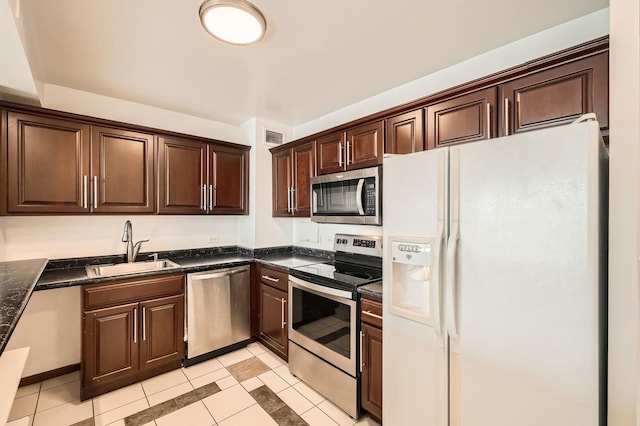 3600 N Lake Shore Dr Unit 1518, Chicago, IL 60613 - kitchen featuring appliances with stainless steel finishes, a sink, dark brown cabinetry, light tile patterned flooring, and dark stone counters
