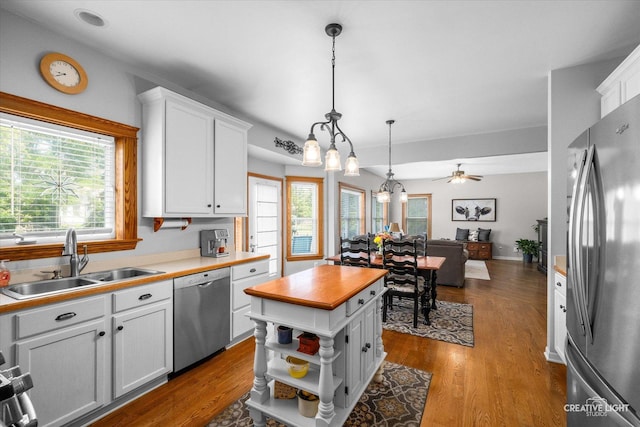 39W382 W Mallory Dr, Geneva, IL 60134 - kitchen with appliances with stainless steel finishes, plenty of natural light, white cabinetry, and pendant lighting