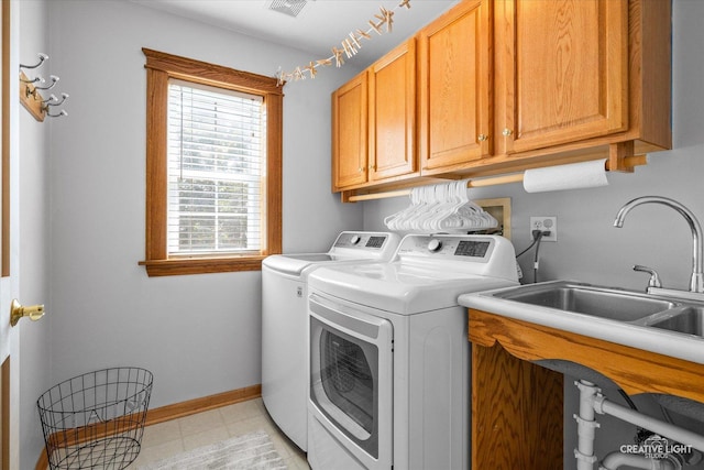 39W382 W Mallory Dr, Geneva, IL 60134 - laundry area featuring washing machine and clothes dryer, cabinet space, and light tile patterned floors