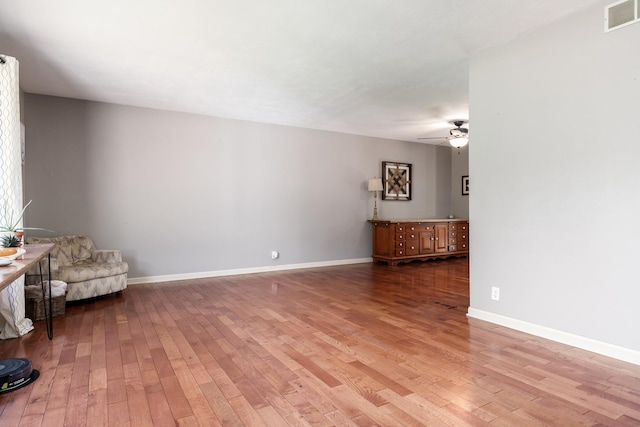 7812 Rhonda Dr, Roscoe, IL 61073 - unfurnished living room with ceiling fan, light wood-style flooring, and baseboards