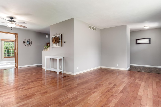 7812 Rhonda Dr, Roscoe, IL 61073 - unfurnished living room with ceiling fan, light wood-style flooring, and baseboards