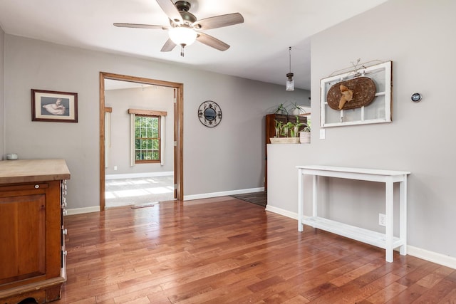 7812 Rhonda Dr, Roscoe, IL 61073 - unfurnished living room featuring ceiling fan, light wood-type flooring, and baseboards