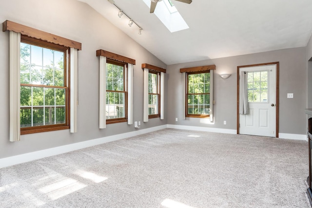 7812 Rhonda Dr, Roscoe, IL 61073 - spare room featuring vaulted ceiling, a skylight, carpet flooring, baseboards, and track lighting