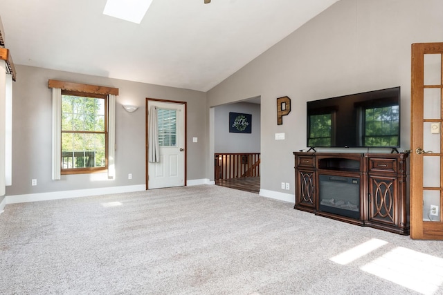 7812 Rhonda Dr, Roscoe, IL 61073 - unfurnished living room with baseboards, vaulted ceiling, carpet, and a skylight