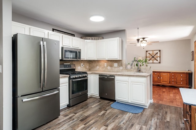 7812 Rhonda Dr, Roscoe, IL 61073 - kitchen with appliances with stainless steel finishes, a sink, dark wood-style floors, ceiling fan, and white cabinetry