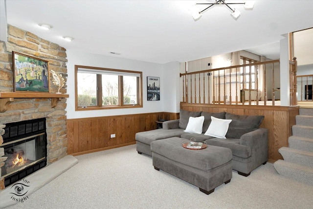 17932 S Alaska Ct Unit 21, Orland Park, IL 60467 - carpeted living room featuring a wainscoted wall, a fireplace, stairway, and wooden walls