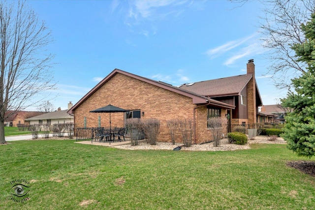 17932 S Alaska Ct Unit 21, Orland Park, IL 60467 - back of property with brick siding, a chimney, and a patio area
