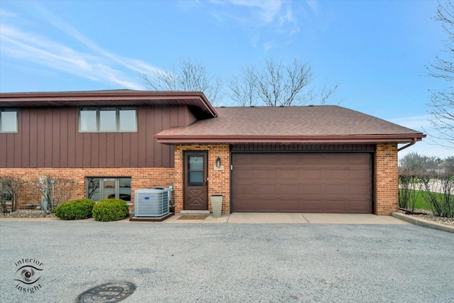 17932 S Alaska Ct Unit 21, Orland Park, IL 60467 - split level home featuring central air condition unit, brick siding, a garage, and driveway
