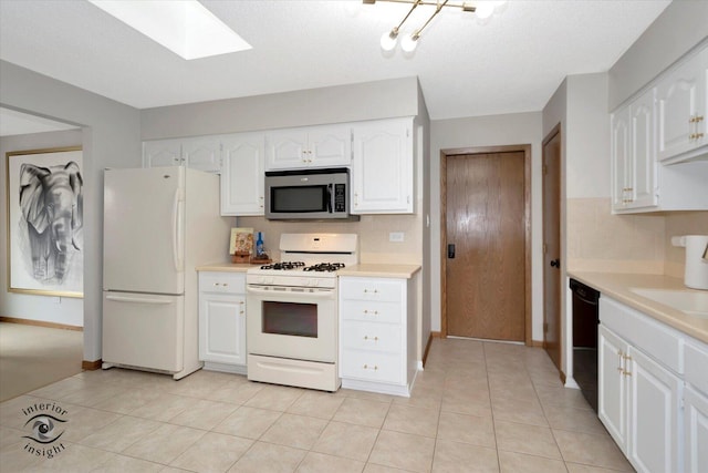 17932 S Alaska Ct Unit 21, Orland Park, IL 60467 - kitchen with white appliances, light countertops, baseboards, and white cabinetry