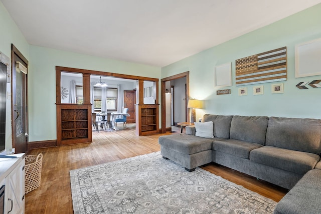 13805 Sharp Dr, Plainfield, IL 60544 - living room featuring wood finished floors, baseboards, and ornate columns