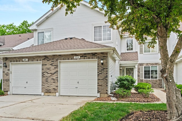 266 Sierra Pass Dr, Schaumburg, IL 60194 - view of front of house featuring driveway, brick siding, a garage, and a shingled roof