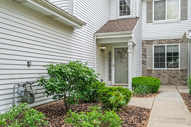 266 Sierra Pass Dr, Schaumburg, IL 60194 - property entrance with roof with shingles and brick siding