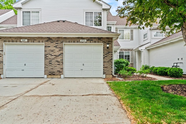 266 Sierra Pass Dr, Schaumburg, IL 60194 - view of front of home featuring driveway, brick siding, a garage, and a shingled roof