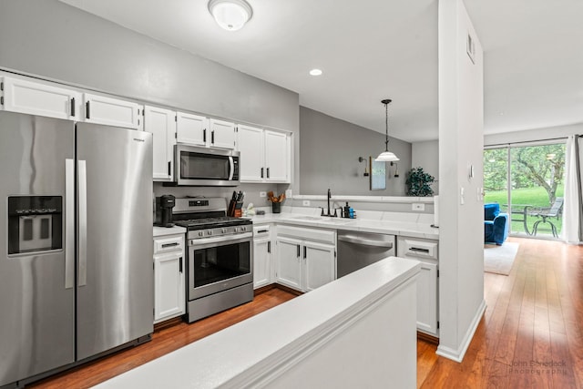 266 Sierra Pass Dr, Schaumburg, IL 60194 - kitchen with stainless steel appliances, white cabinetry, a sink, light countertops, and recessed lighting