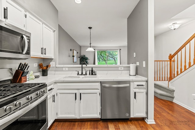 266 Sierra Pass Dr, Schaumburg, IL 60194 - kitchen with stainless steel appliances, a sink, white cabinets, wood finished floors, and light stone counters