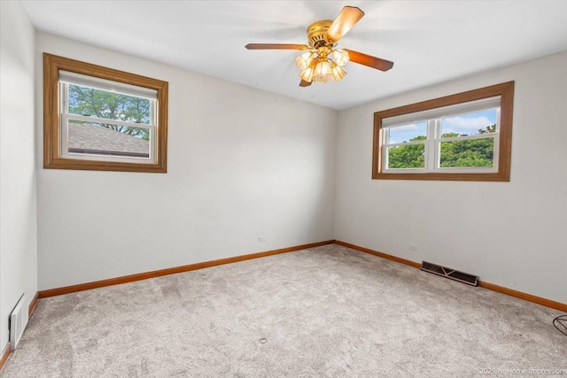 9144 S Trumbull Ave, Evergreen Park, IL 60805 - carpeted empty room with baseboards and a ceiling fan