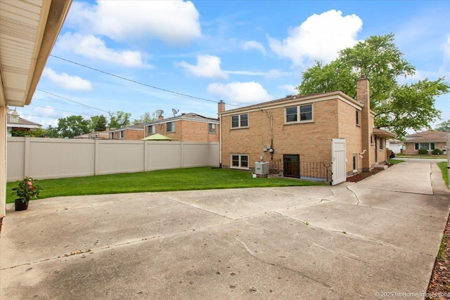 9144 S Trumbull Ave, Evergreen Park, IL 60805 - back of house with a chimney, a patio area, central air condition unit, and brick siding