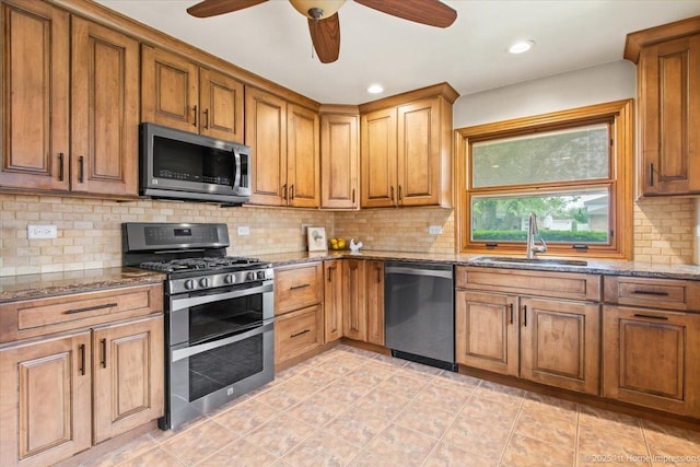 9144 S Trumbull Ave, Evergreen Park, IL 60805 - kitchen featuring stainless steel appliances, a sink, light stone counters, brown cabinets, and tasteful backsplash