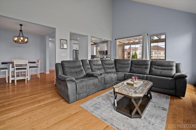 12709 Wild Rye Ct, Plainfield, IL 60585 - living room featuring a chandelier, light wood finished floors, and a high ceiling