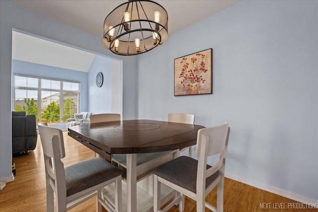 12709 Wild Rye Ct, Plainfield, IL 60585 - dining area with a chandelier, light wood finished floors, and baseboards