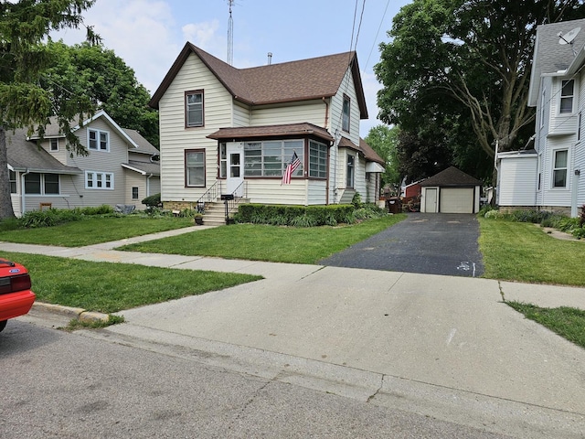 427 W Hurlbut Ave, Belvidere, IL 61008 - traditional home with a garage, an outdoor structure, a shingled roof, entry steps, and a front lawn
