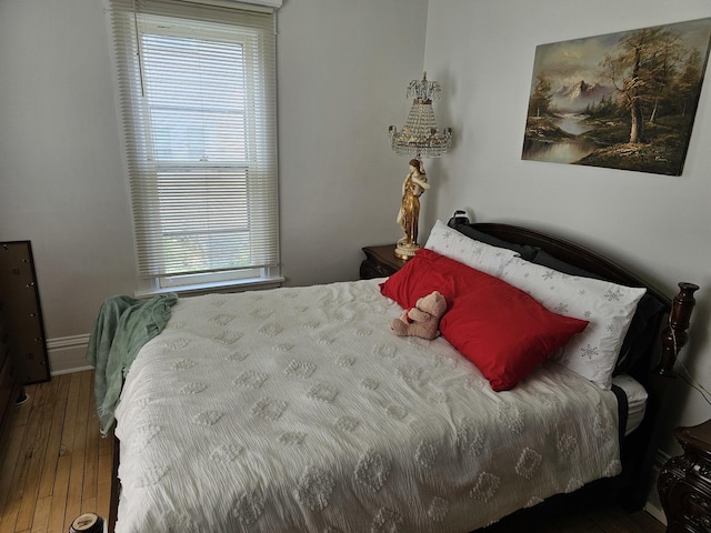 427 W Hurlbut Ave, Belvidere, IL 61008 - bedroom with multiple windows, hardwood / wood-style floors, and baseboards