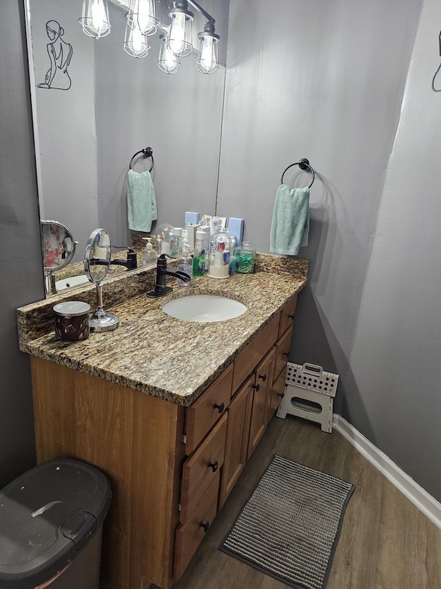 427 W Hurlbut Ave, Belvidere, IL 61008 - bathroom featuring wood finished floors, vanity, and baseboards