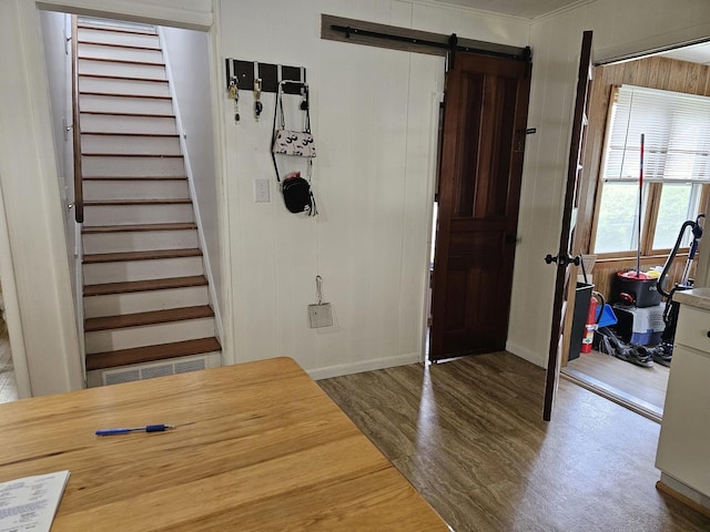 427 W Hurlbut Ave, Belvidere, IL 61008 - foyer entrance featuring wood finished floors, a barn door, stairs, and baseboards