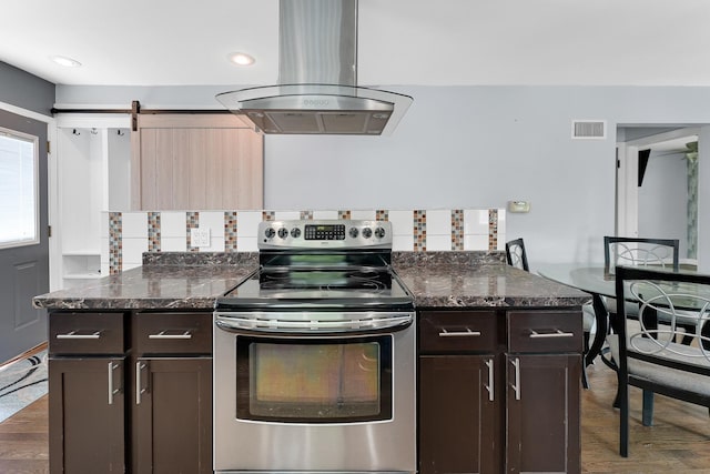 301 W Graham Ave, Lombard, IL 60148 - kitchen featuring electric range, island range hood, dark wood-type flooring, dark brown cabinetry, and dark stone counters