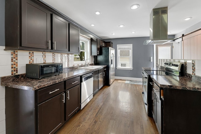301 W Graham Ave, Lombard, IL 60148 - kitchen featuring appliances with stainless steel finishes, island range hood, wood finished floors, backsplash, and baseboards
